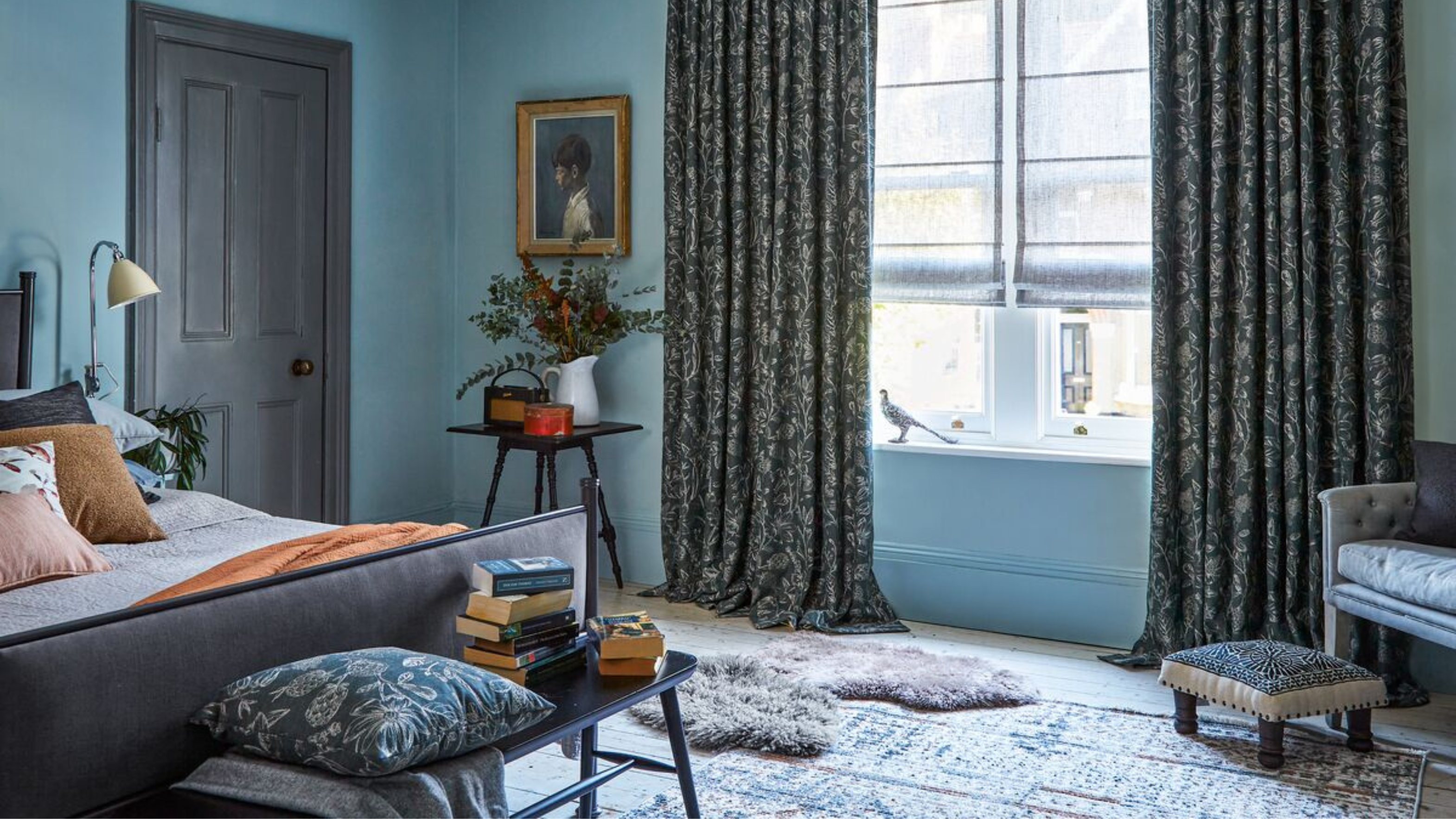 Blue decorated bedroom with blackout curtains from Hillarys