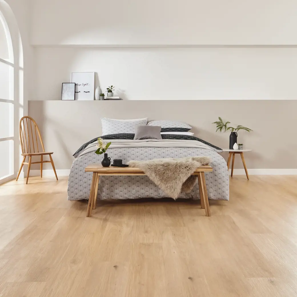 Van Gogh Canadian Nude Oak mid brown LVT flooring laid in a bedroom